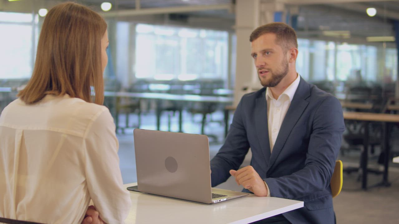 Two business partners having a focused conversation in an office